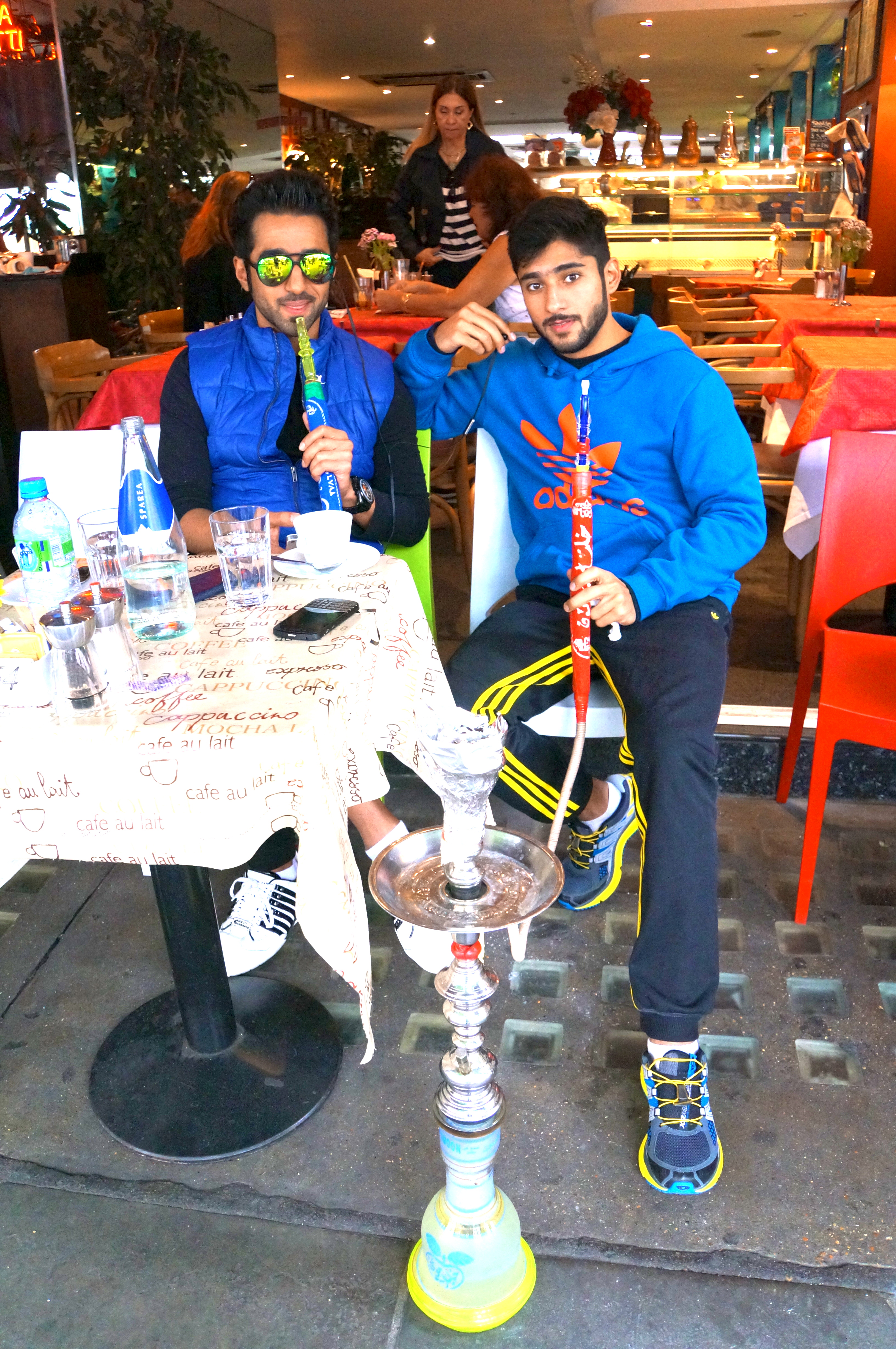 Hookah smokers in a cafe outside Herrods.